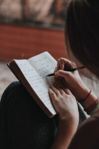 Girl writing her goals for future